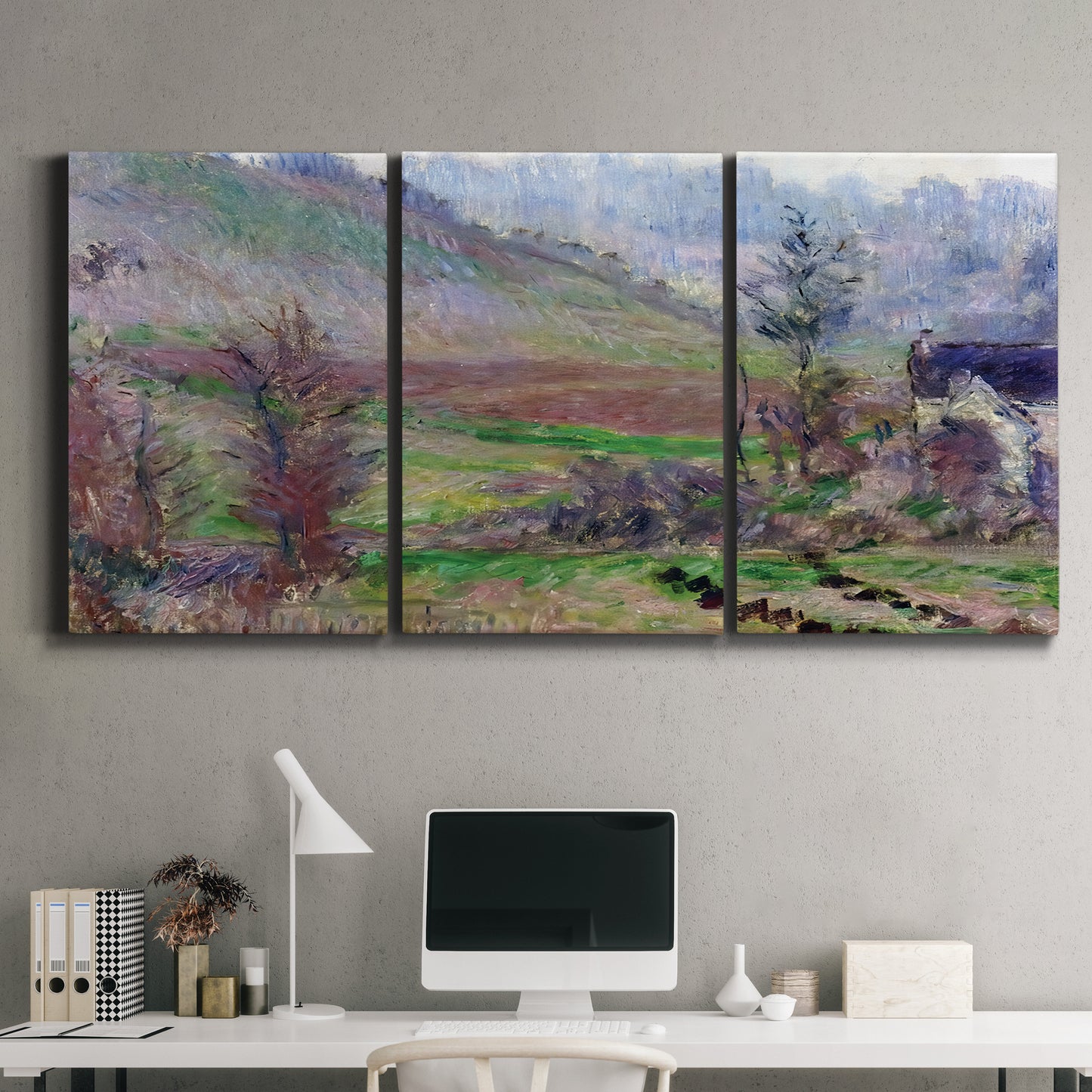 Three-panel canvas wall art featuring cliffside cottage overlooking sea, displayed above a desk in a home office.