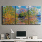 Three-panel canvas wall art featuring wide river landscape, displayed above a desk in a home office.