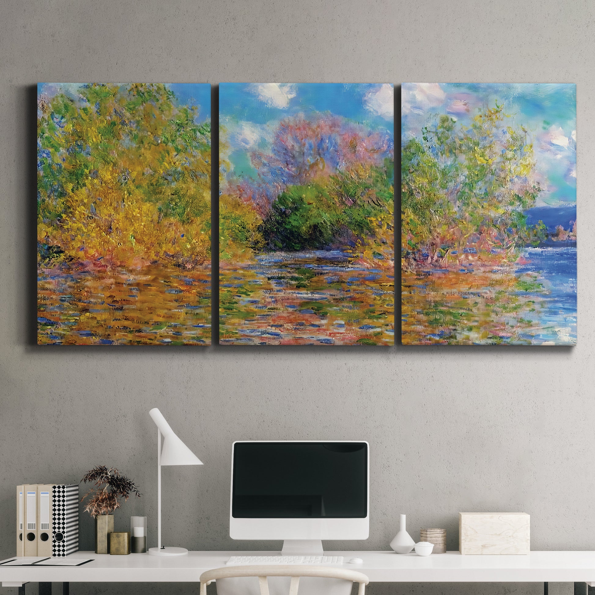 Three-panel canvas wall art featuring wide river landscape, displayed above a desk in a home office.