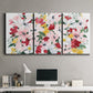 Three-panel canvas wall art featuring joyful spring floral composition, displayed above a desk in a home office.