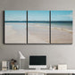 Three-panel canvas wall art featuring white sand beach with gentle waves, displayed above a desk in a home office.