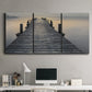 Three-panel canvas wall art featuring sunset over water photograph, displayed above a desk in a home office.