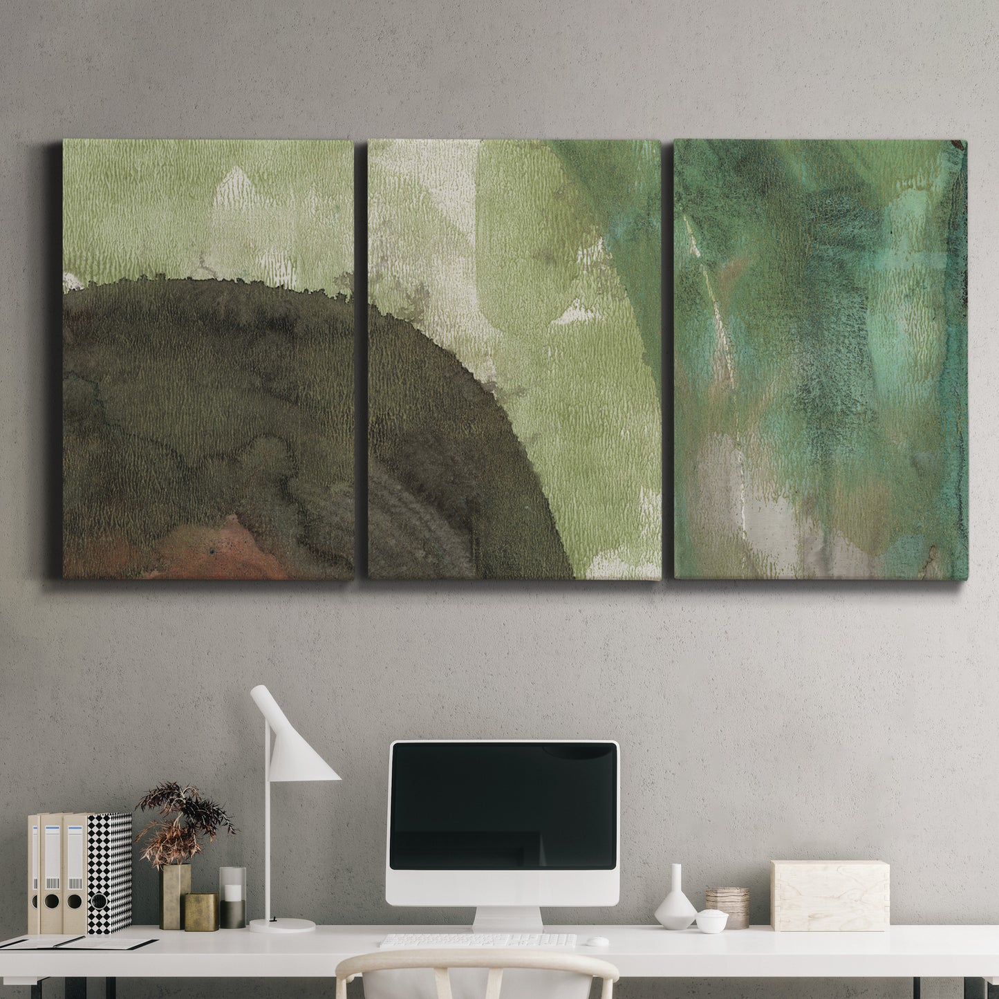 Three-panel canvas wall art featuring layered green abstract composition, displayed above a desk in a home office.