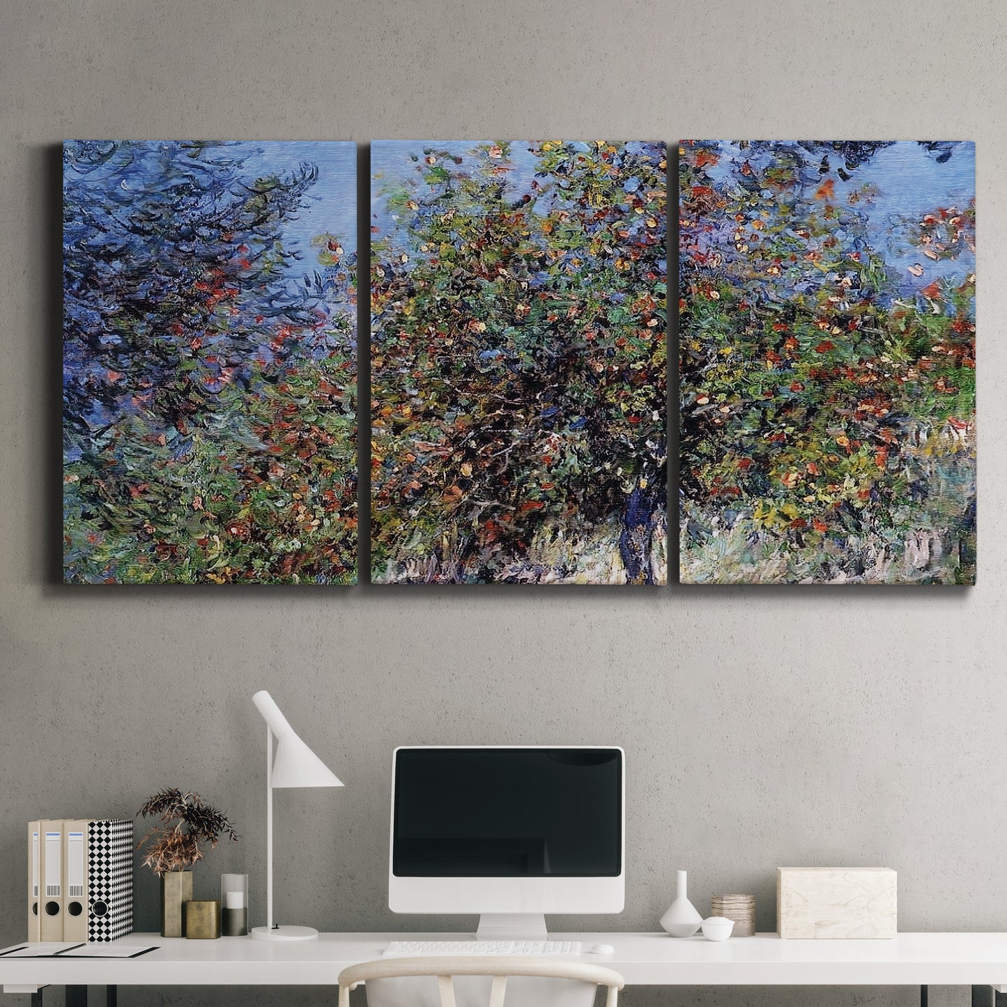 Three-panel canvas wall art featuring orchard of trees in spring bloom, displayed above a desk in a home office.
