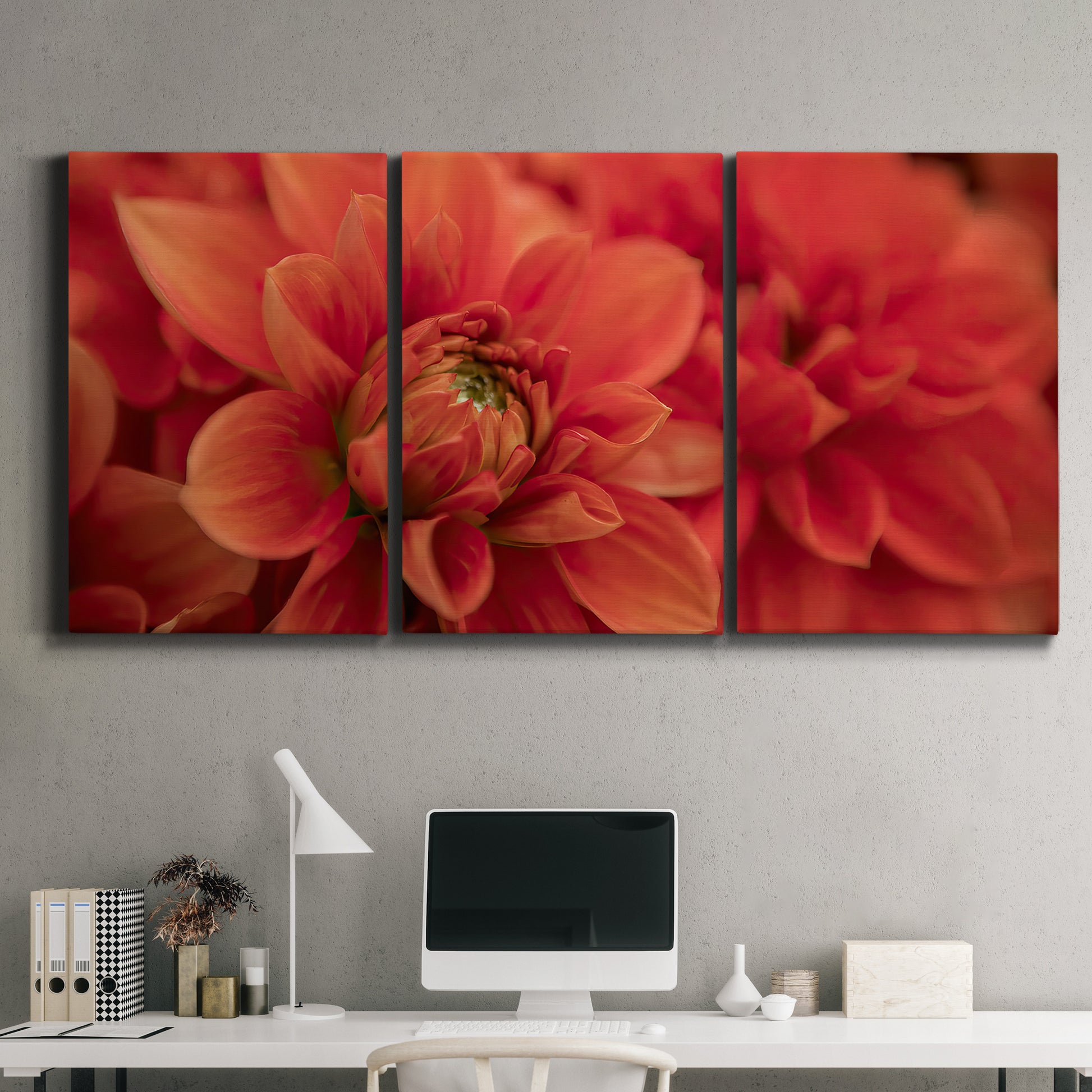 Three-panel canvas wall art featuring vivid red floral close up, displayed above a desk in a home office.