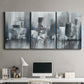 Three-panel canvas wall art featuring urban cityscape rendered in blue tones, displayed above a desk in a home office.