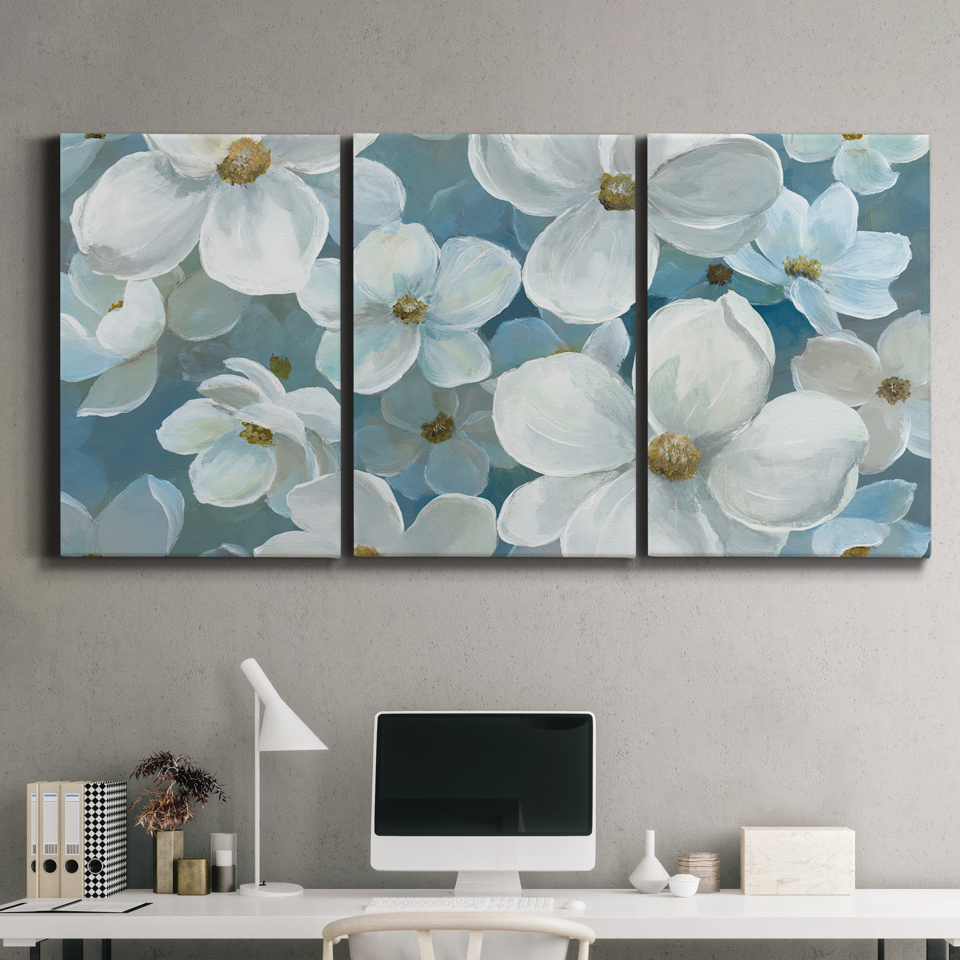 Three-panel canvas wall art featuring soft white floral abstraction, displayed above a desk in a home office.
