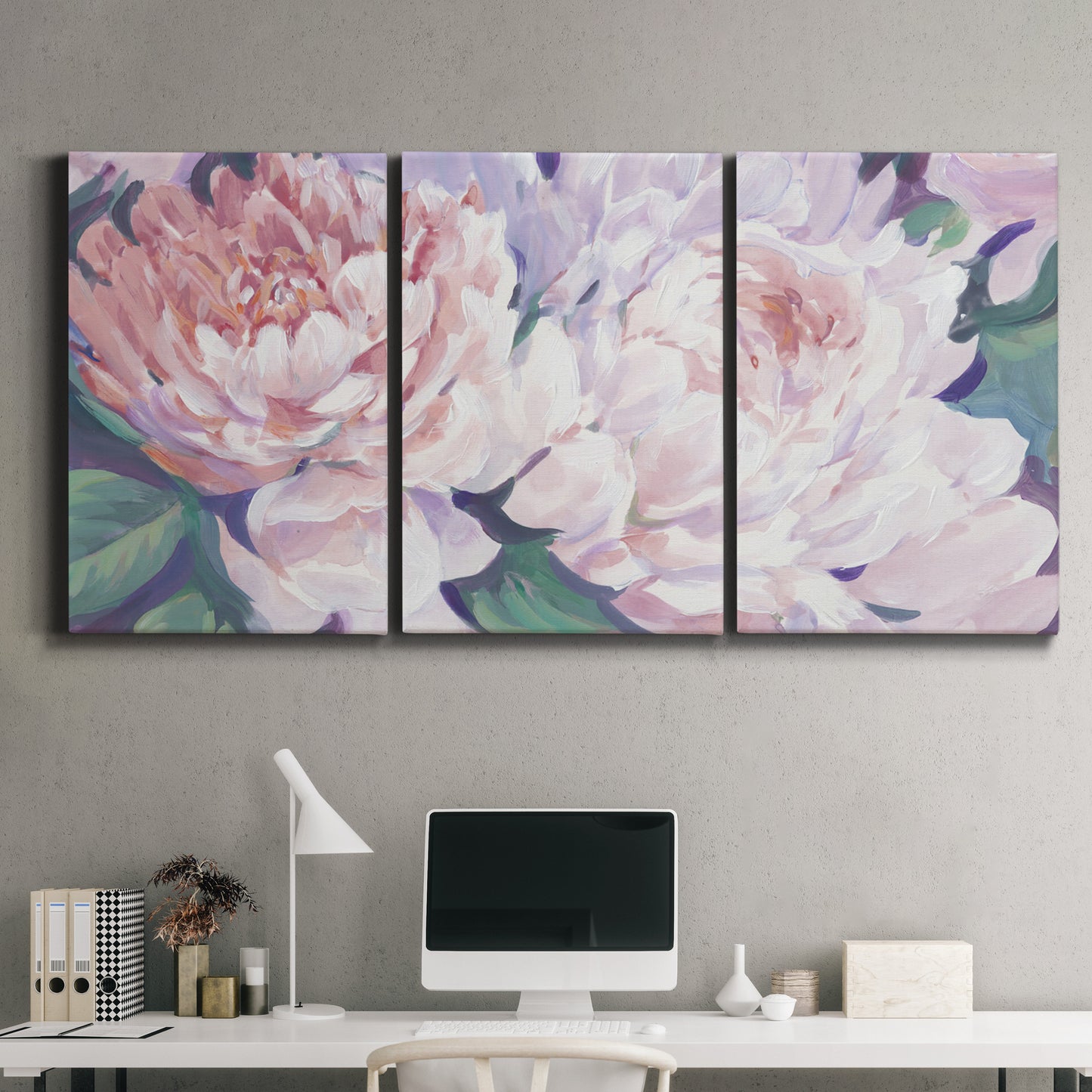 Three-panel canvas wall art featuring soft pink peonies in bloom, displayed above a desk in a home office.