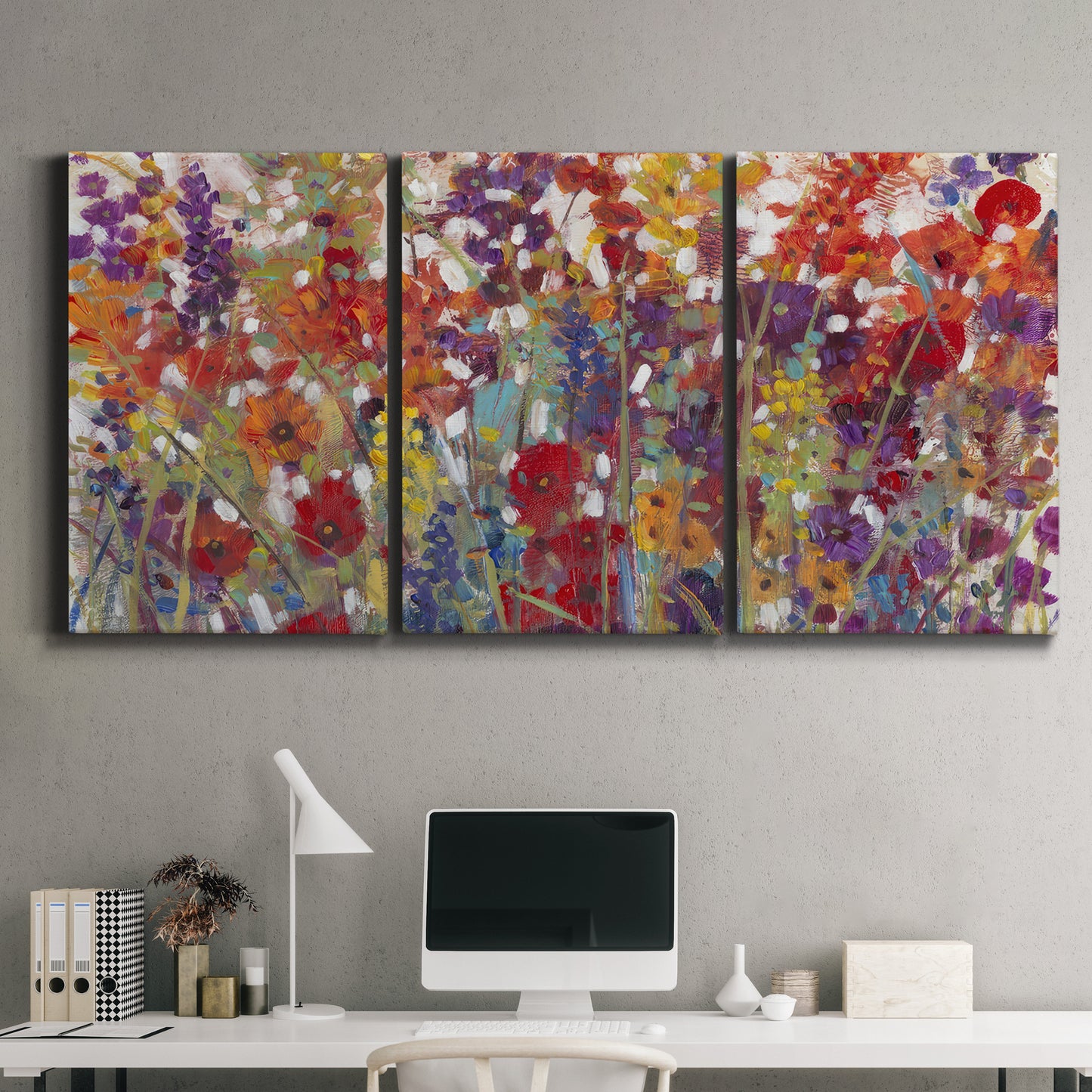 Three-panel canvas wall art featuring colorful floral arrangement, displayed above a desk in a home office.