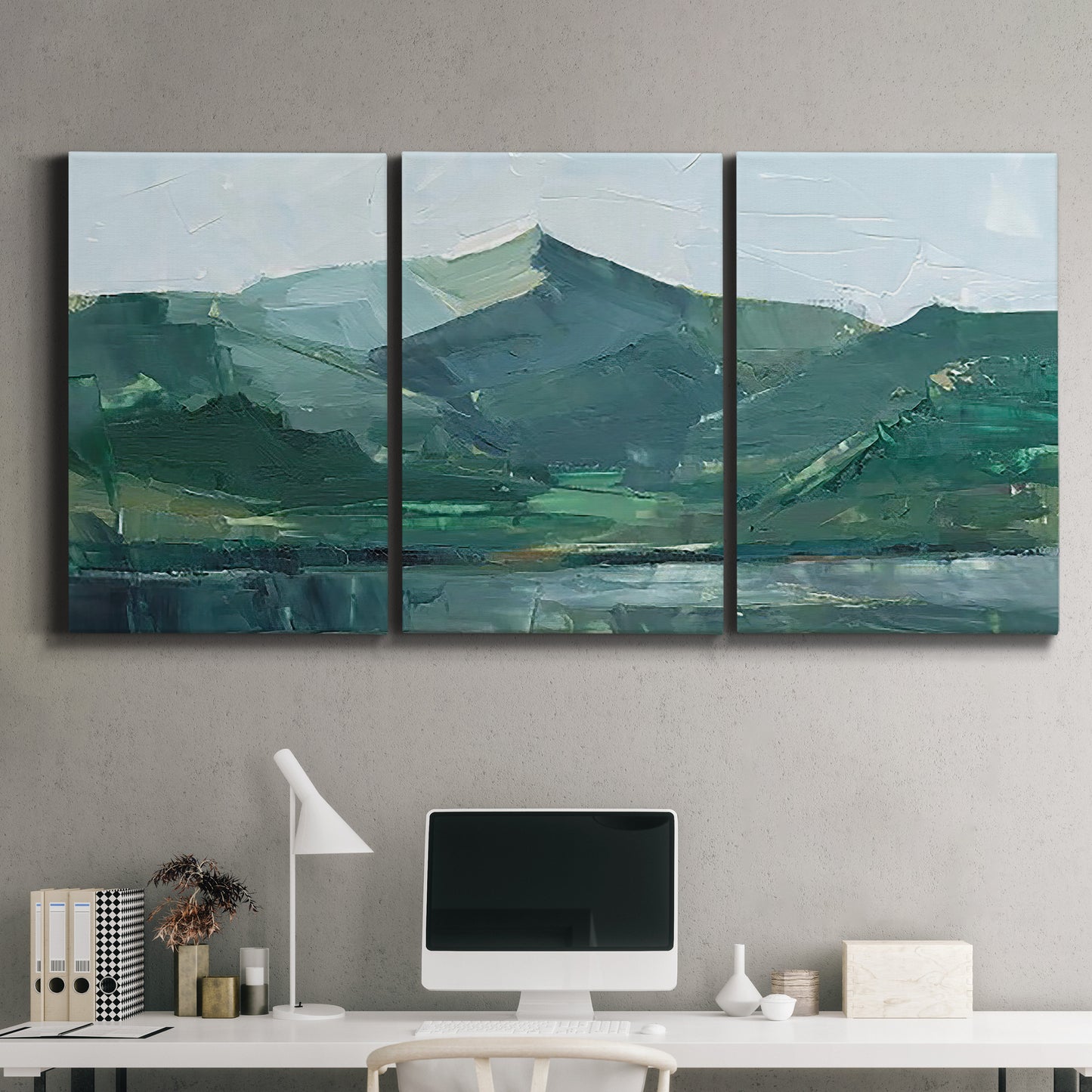 Three-panel canvas wall art featuring muted mountain range in grey tones, displayed above a desk in a home office.