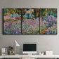 Three-panel canvas wall art featuring blooming irises in garden bed, displayed above a desk in a home office.