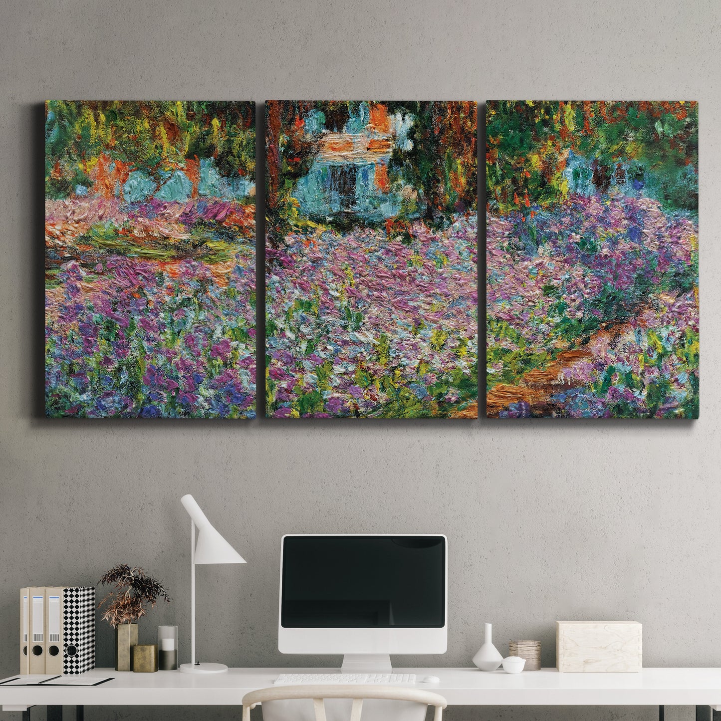 Three-panel canvas wall art featuring blooming irises in garden bed, displayed above a desk in a home office.