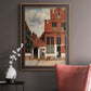 Realist city street scene by Johannes Vermeer in an ornate bronzed mahogany wood frame displayed in a neutral interior setting.