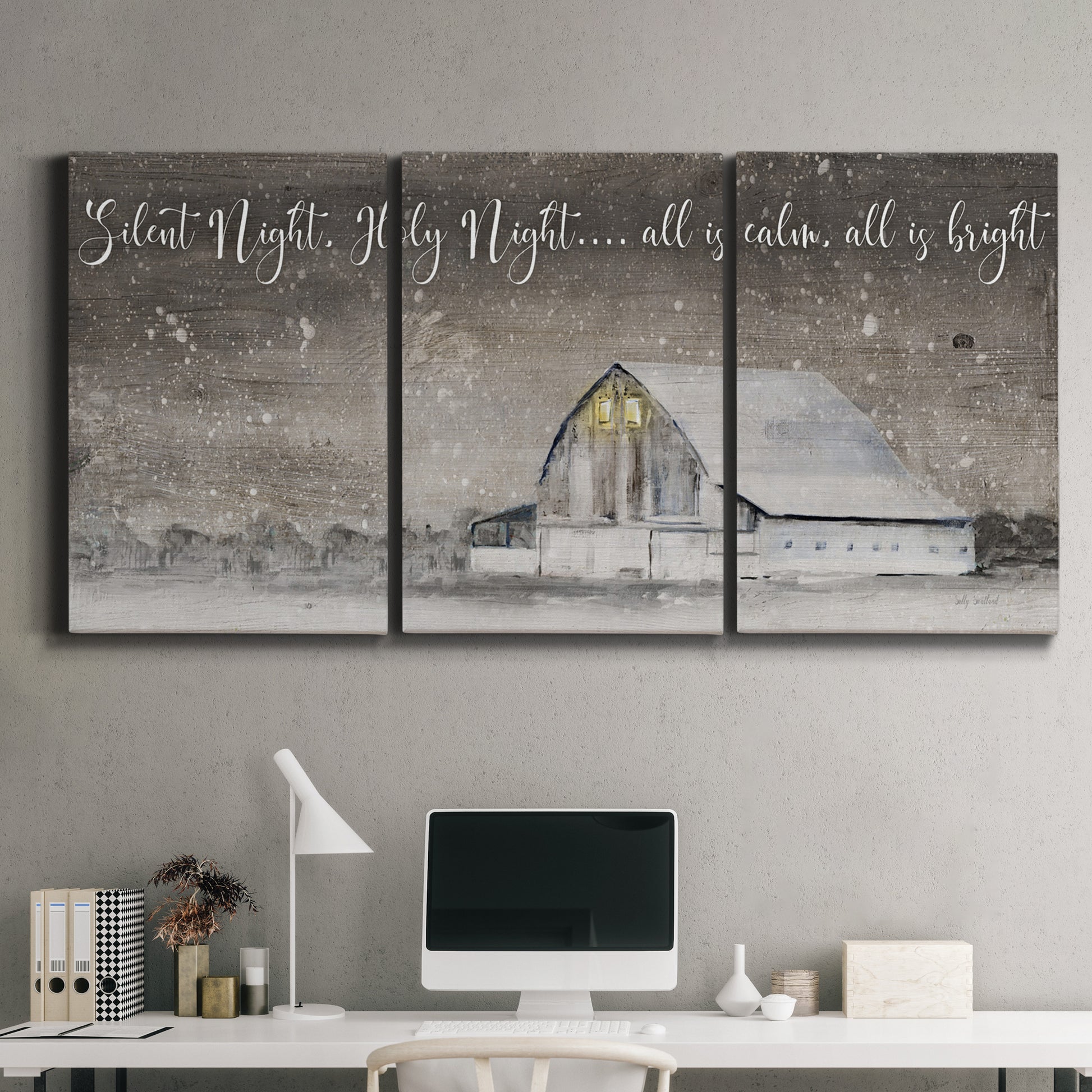 Three-panel canvas wall art featuring rustic winter holiday text art, displayed above a desk in a home office.