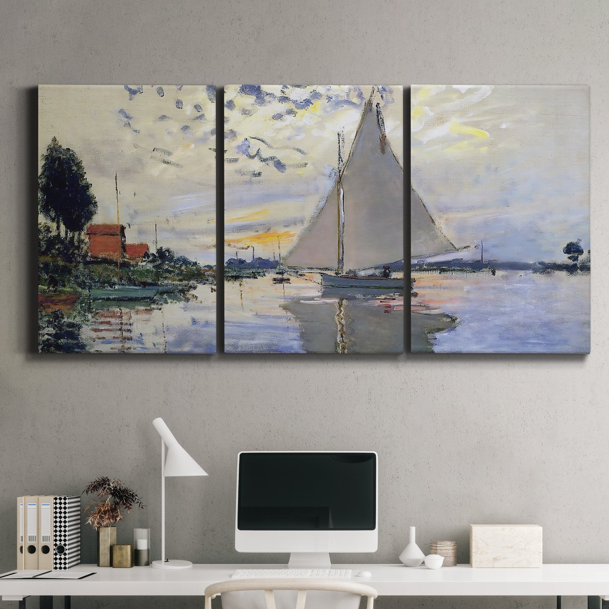Three-panel canvas wall art featuring riverside village shoreline, displayed above a desk in a home office.