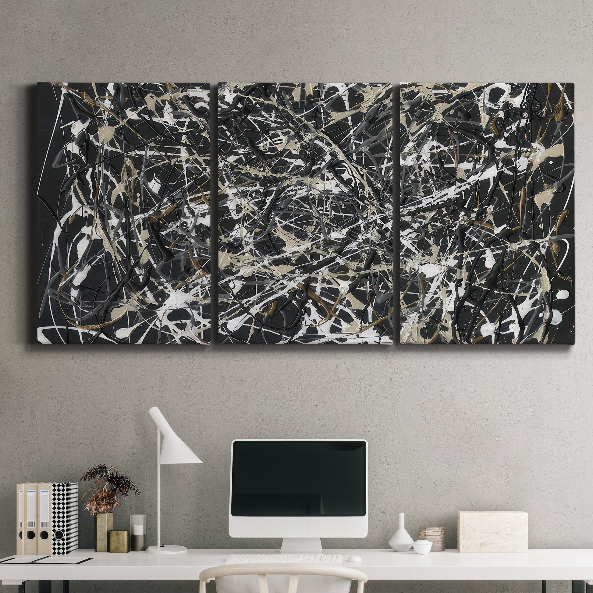 Three-panel canvas wall art featuring energetic expressionist abstract splatter, displayed above a desk in a home office.