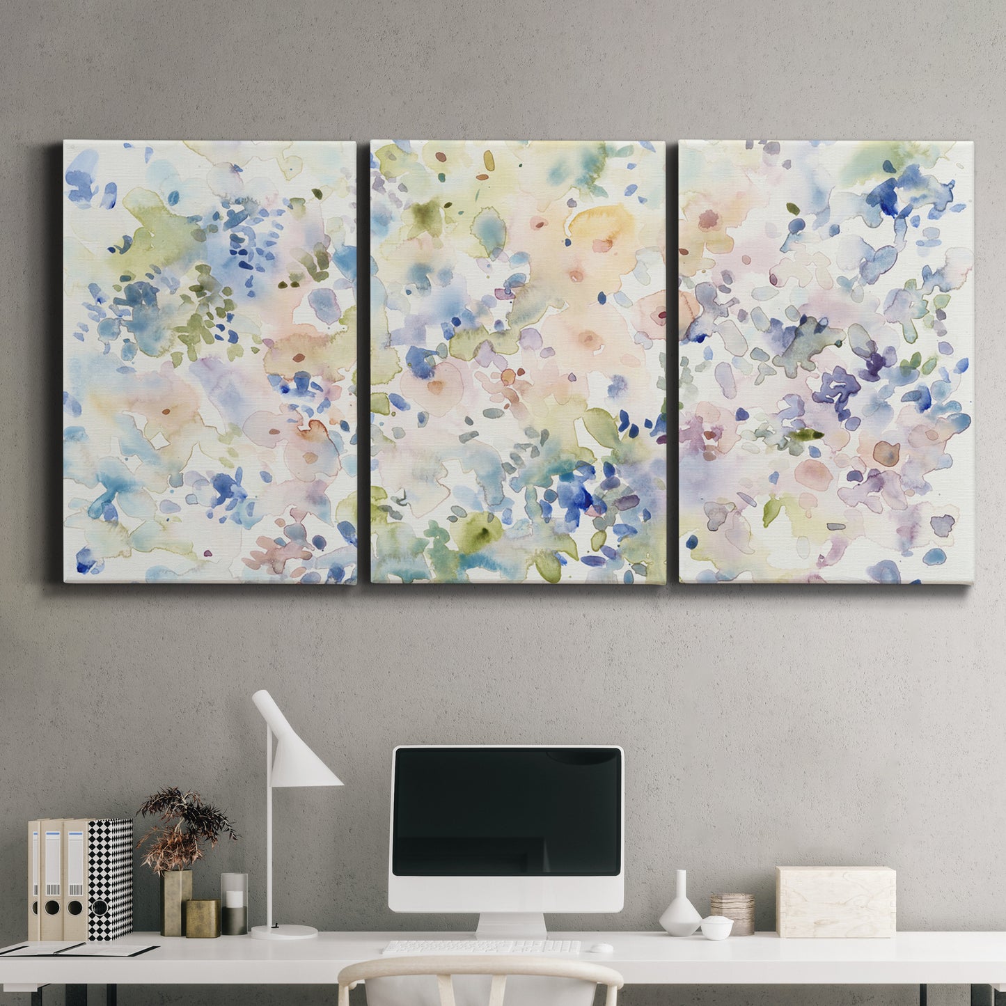 Three-panel canvas wall art featuring flowing abstract watercolor, displayed above a desk in a home office.