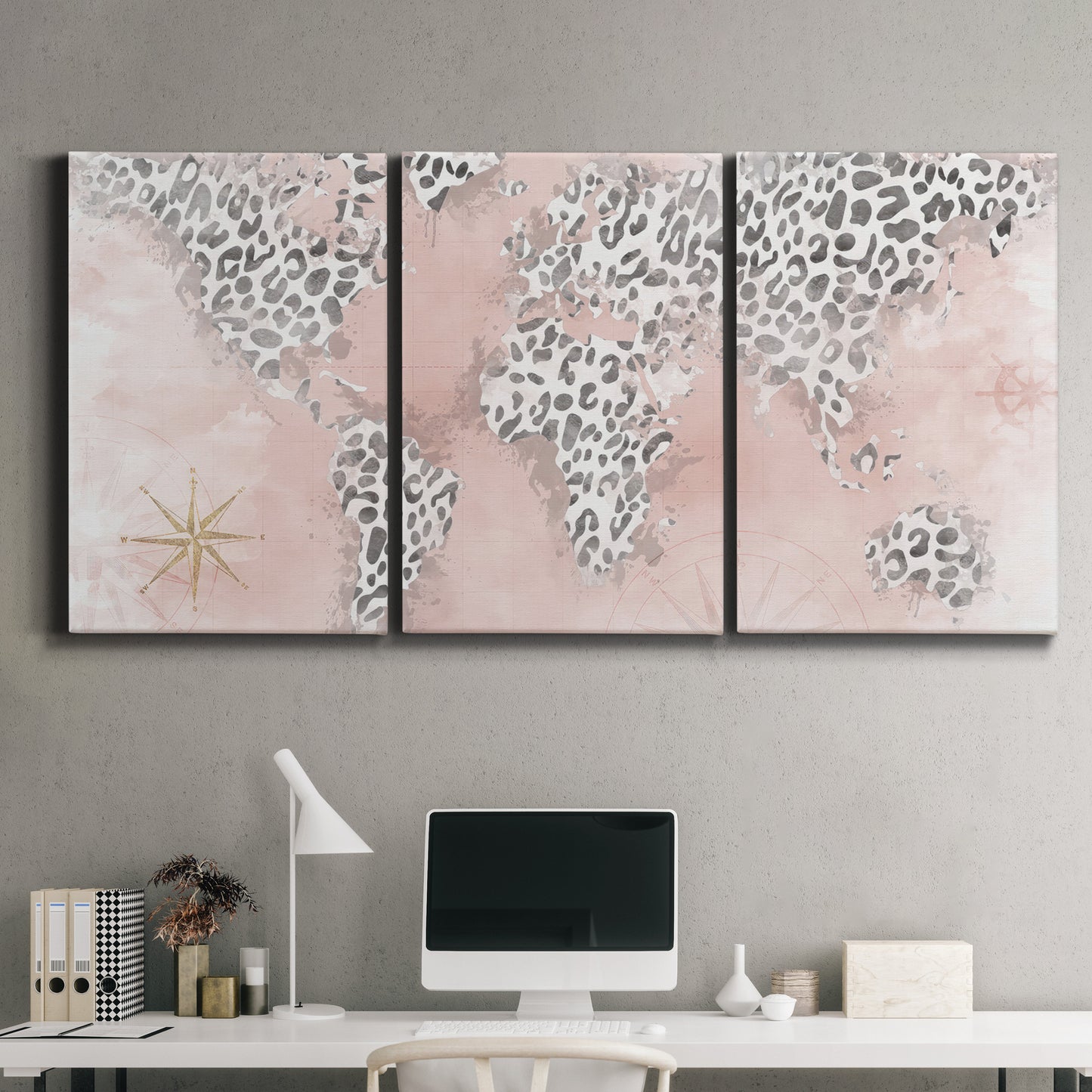 Three-panel canvas wall art featuring stylized pink cheetah world map, displayed above a desk in a home office.