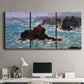 Three-panel canvas wall art featuring storm waves battering rocky coast, displayed above a desk in a home office.