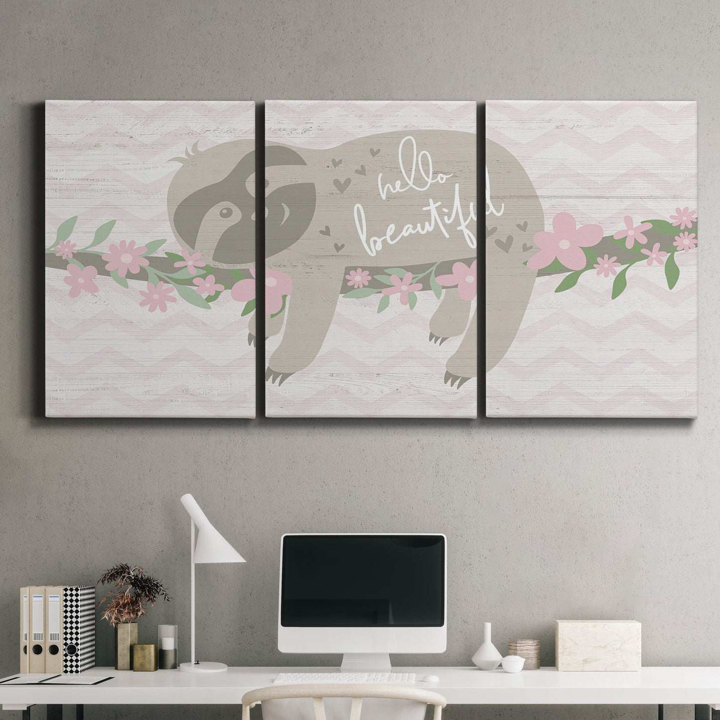 Three-panel canvas wall art featuring sloth with floral decorative elements, displayed above a desk in a home office.