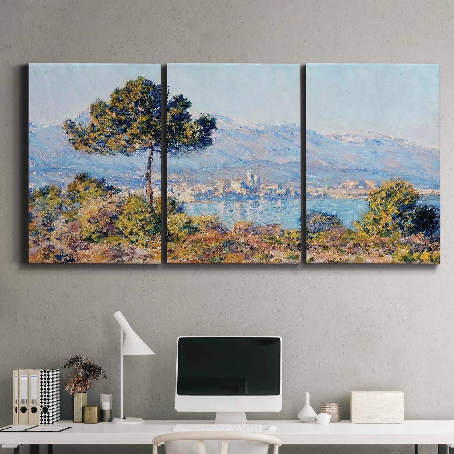 Three-panel canvas wall art featuring coastal town viewed from hillside, displayed above a desk in a home office.