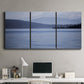 Three-panel canvas wall art featuring calm blue water landscape, displayed above a desk in a home office.