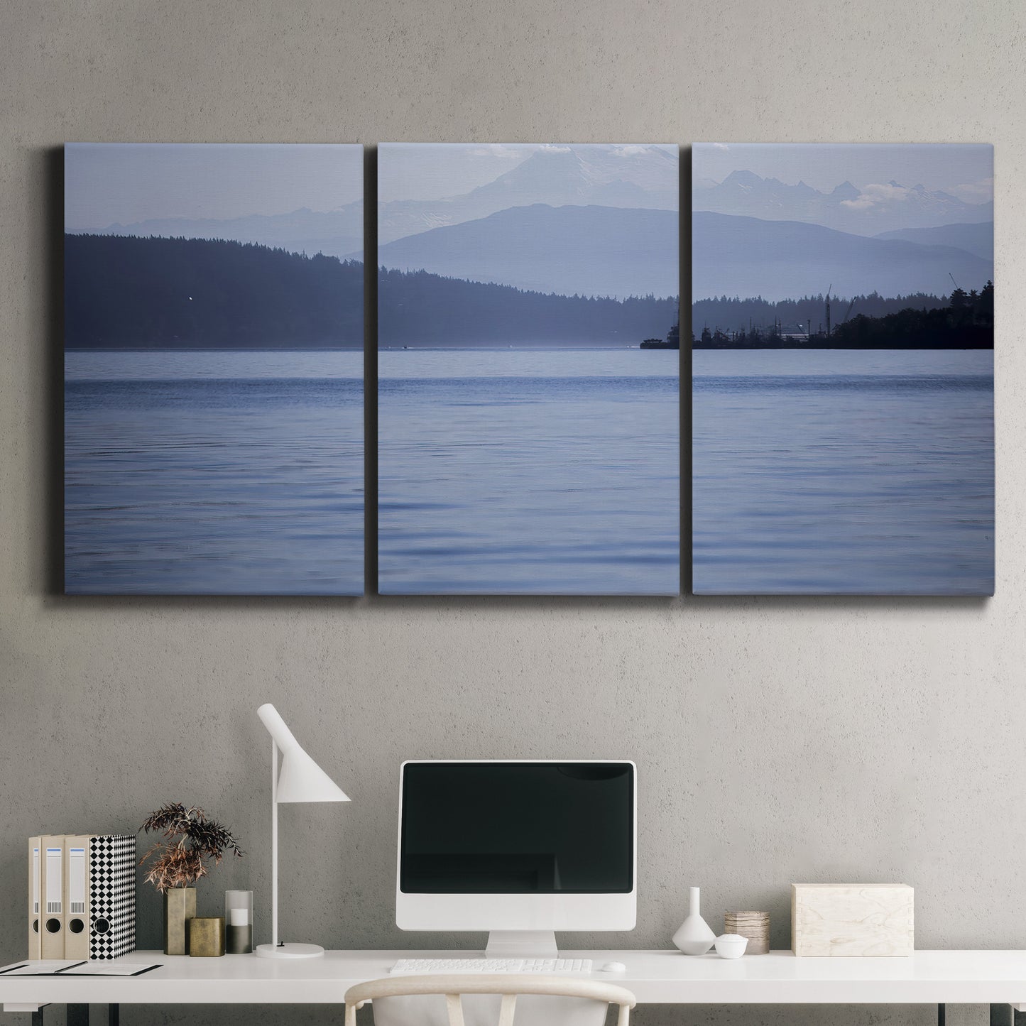 Three-panel canvas wall art featuring calm blue water landscape, displayed above a desk in a home office.