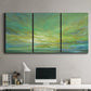 Three-panel canvas wall art featuring coastal shoreline under open sky, displayed above a desk in a home office.