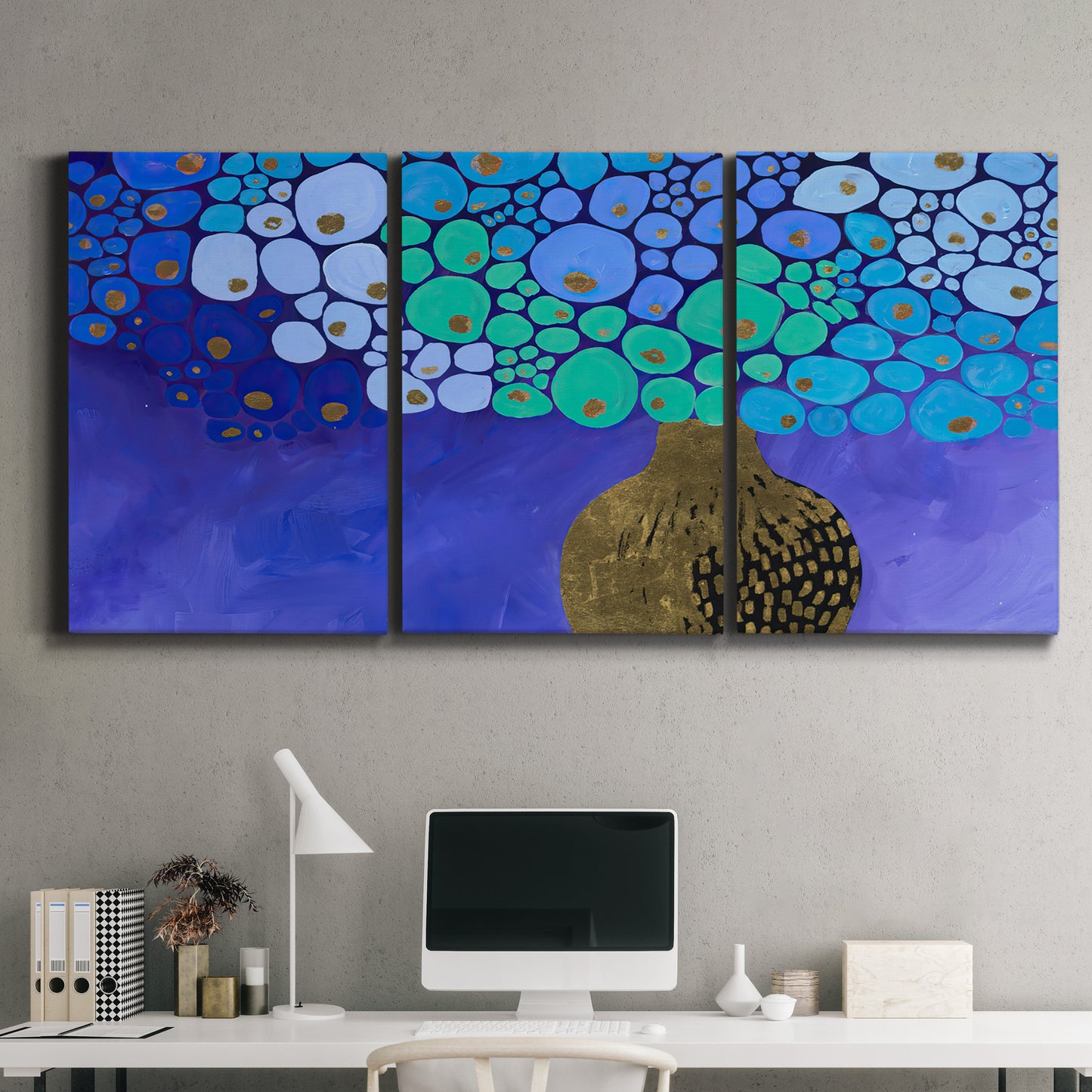 Three-panel canvas wall art featuring blue poppy floral abstraction, displayed above a desk in a home office.