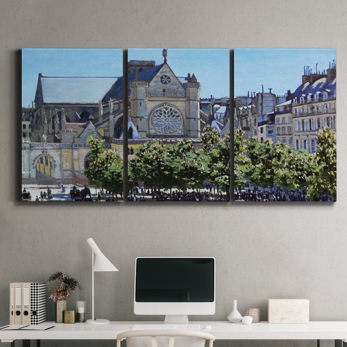 Three-panel canvas wall art featuring gothic church within city setting, displayed above a desk in a home office.