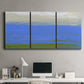 Three-panel canvas wall art featuring abstract coastal inlet landscape, displayed above a desk in a home office.