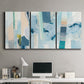 Three-panel canvas wall art featuring layered geometric abstract strata forms, displayed above a desk in a home office.