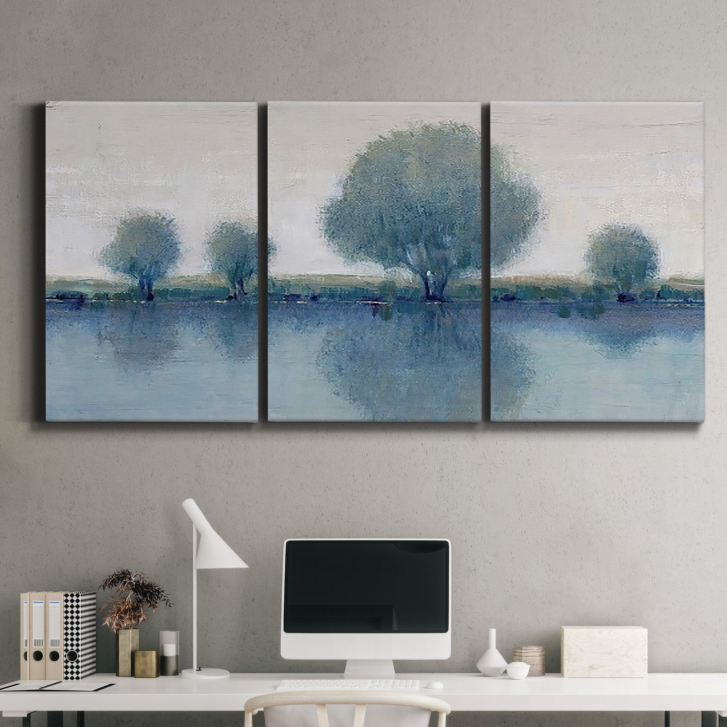 Three-panel canvas wall art featuring calm afternoon river reflection, displayed above a desk in a home office.