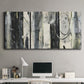 Three-panel canvas wall art featuring vertical abstract tree forms, displayed above a desk in a home office.
