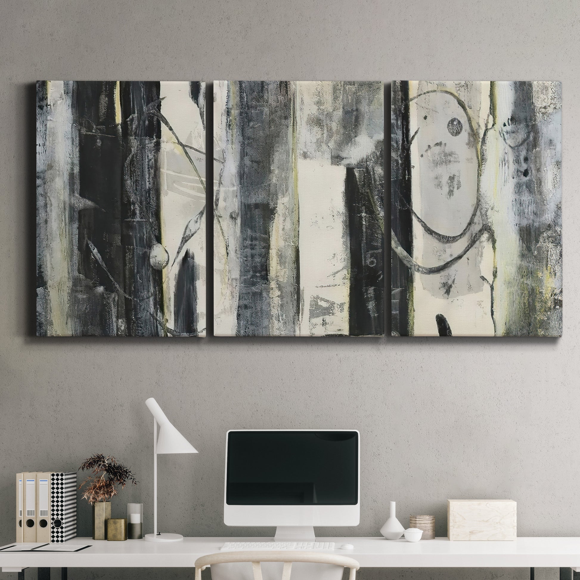 Three-panel canvas wall art featuring vertical abstract tree forms, displayed above a desk in a home office.