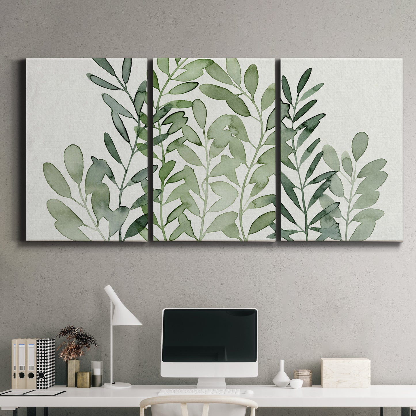 Three-panel canvas wall art featuring foraged leafy greens botanical study, displayed above a desk in a home office.