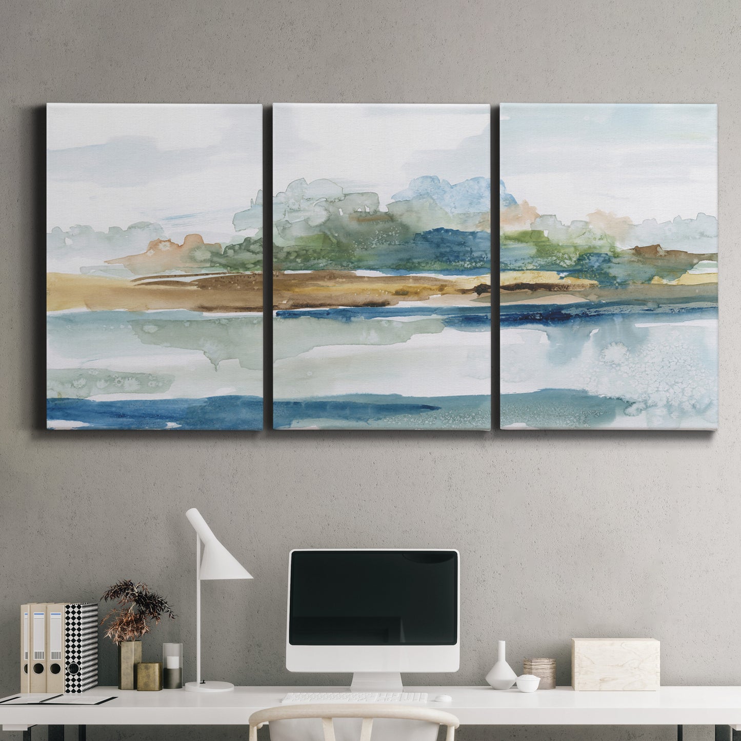 Three-panel canvas wall art featuring flowing blue abstract watercolor, displayed above a desk in a home office.
