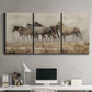 Three-panel canvas wall art featuring wild horses roaming open terrain, displayed above a desk in a home office.