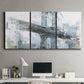 Three-panel canvas wall art featuring urban cityscape with architectural forms, displayed above a desk in a home office.