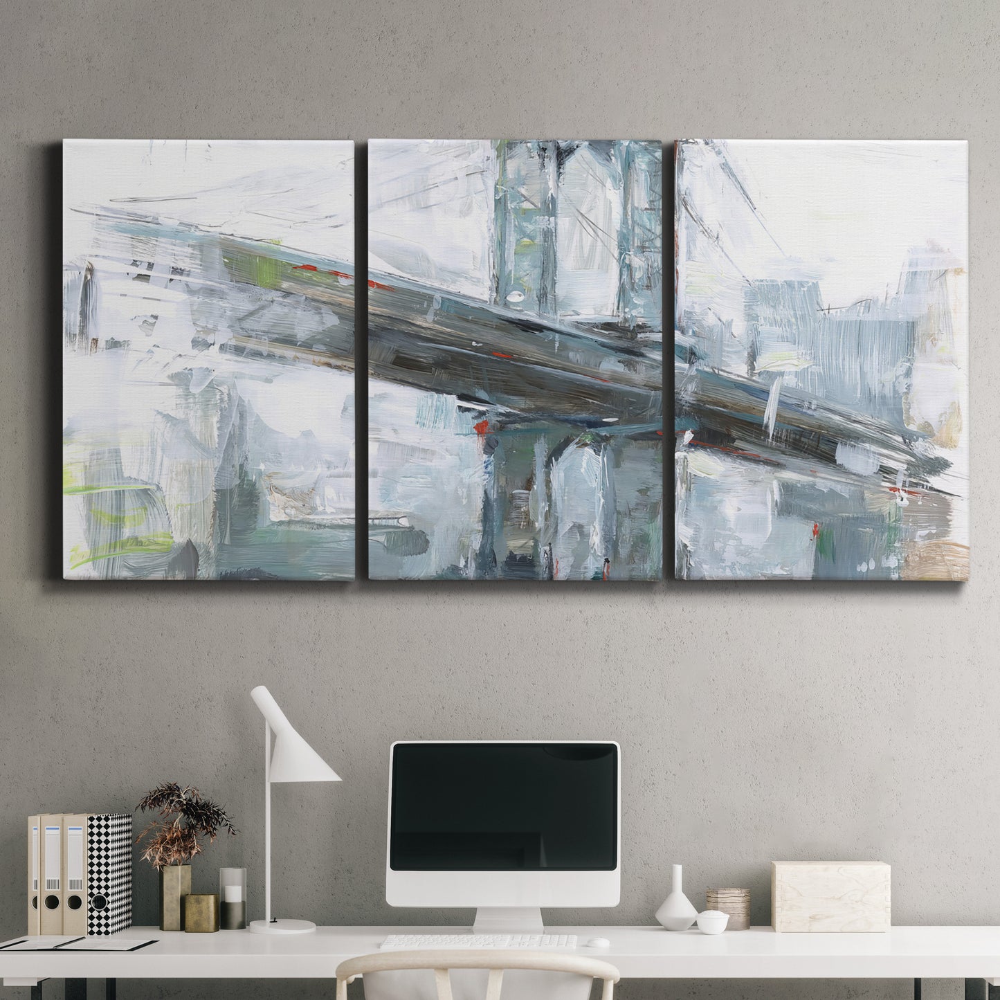 Three-panel canvas wall art featuring urban cityscape with architectural forms, displayed above a desk in a home office.