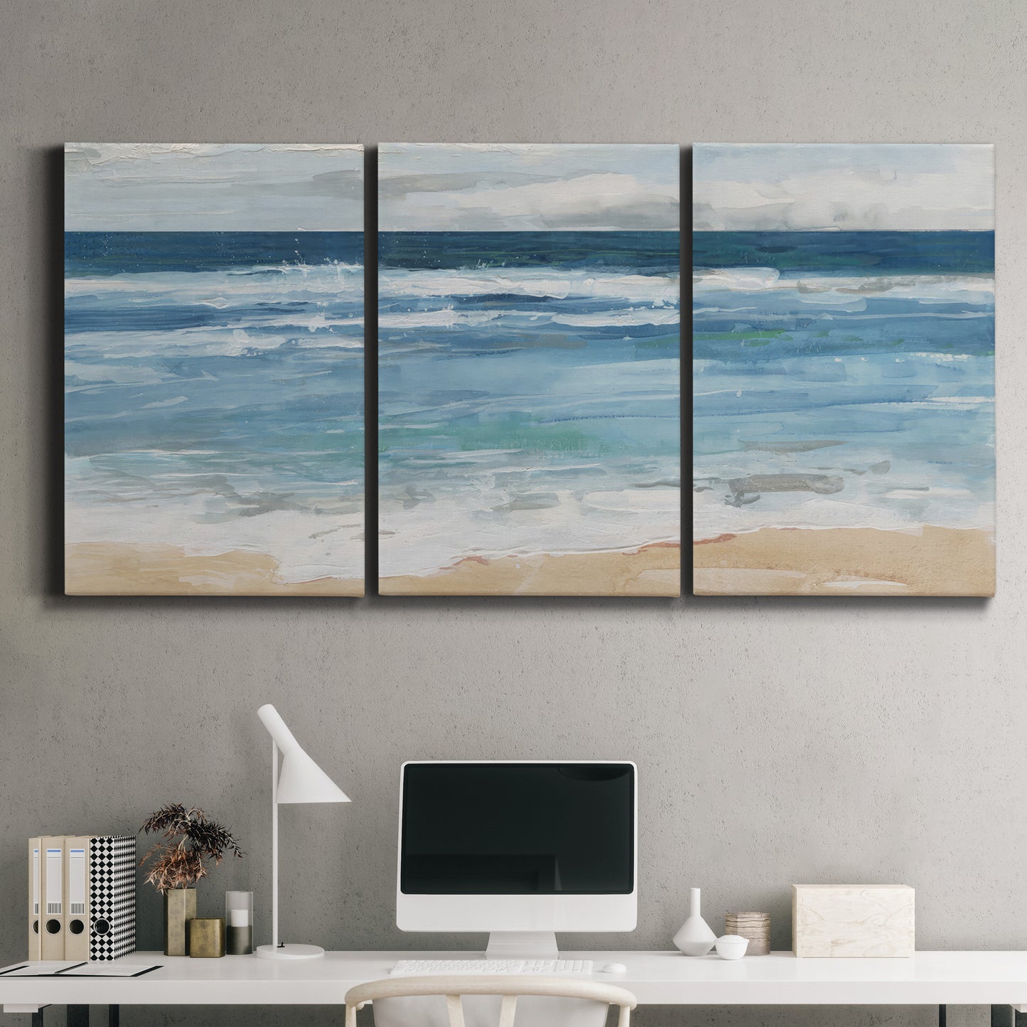 Three-panel canvas wall art featuring rolling ocean waves near shore, displayed above a desk in a home office.
