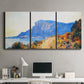 Three-panel canvas wall art featuring winding red road hillside, displayed above a desk in a home office.