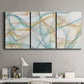 Three-panel canvas wall art featuring flowing abstract curves and wave patterns, displayed above a desk in a home office.