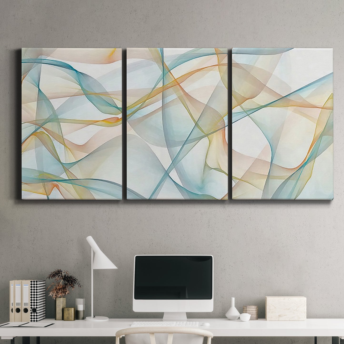 Three-panel canvas wall art featuring flowing abstract curves and wave patterns, displayed above a desk in a home office.