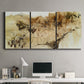 Three-panel canvas wall art featuring muted abstract with metallic gold accents, displayed above a desk in a home office.