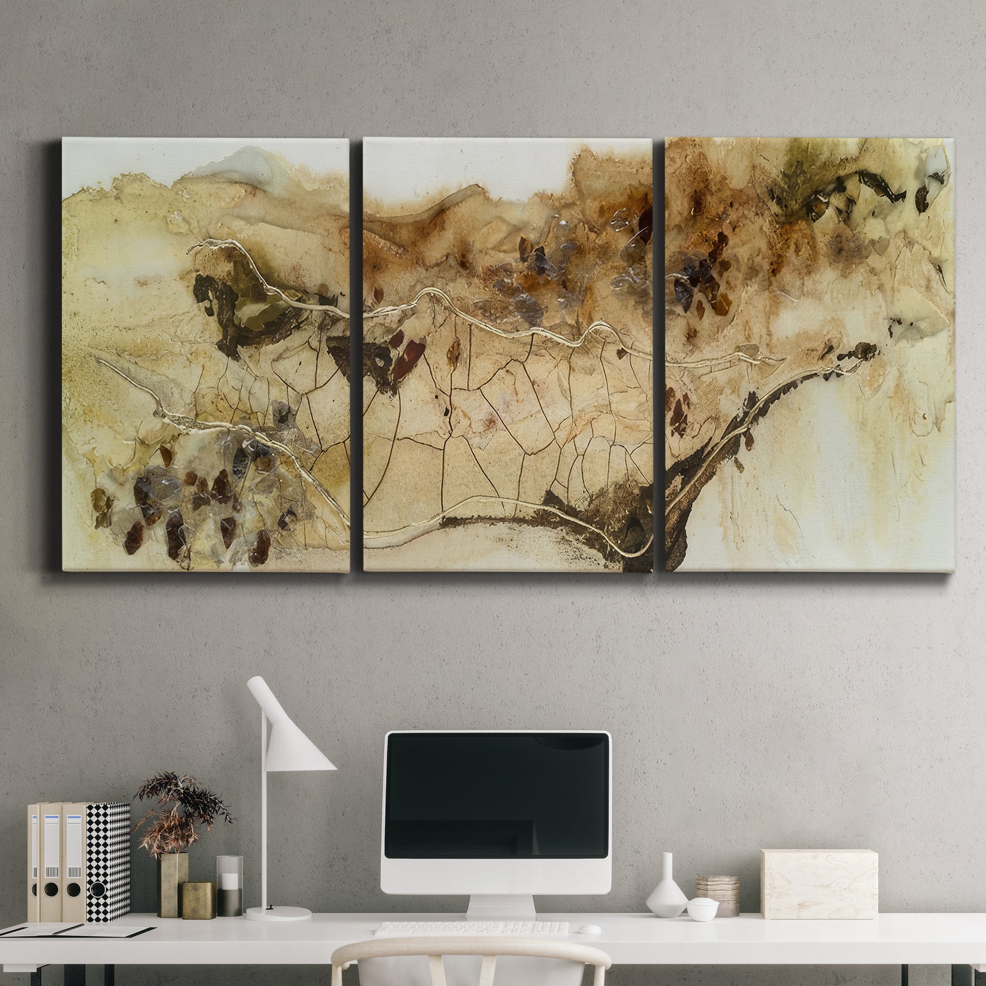 Three-panel canvas wall art featuring muted abstract with metallic gold accents, displayed above a desk in a home office.