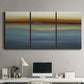 Three-panel canvas wall art featuring horizontal abstract coastal color bands, displayed above a desk in a home office.