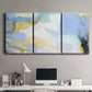 Three-panel canvas wall art featuring soft abstract spring watercolor tones, displayed above a desk in a home office.