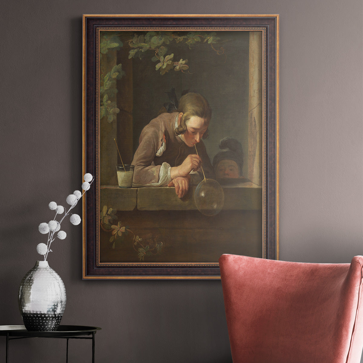 Classical genre painting of a child blowing soap bubbles by Jean-Siméon Chardin in an ornate bronzed mahogany wood frame displayed in a neutral interior setting.
