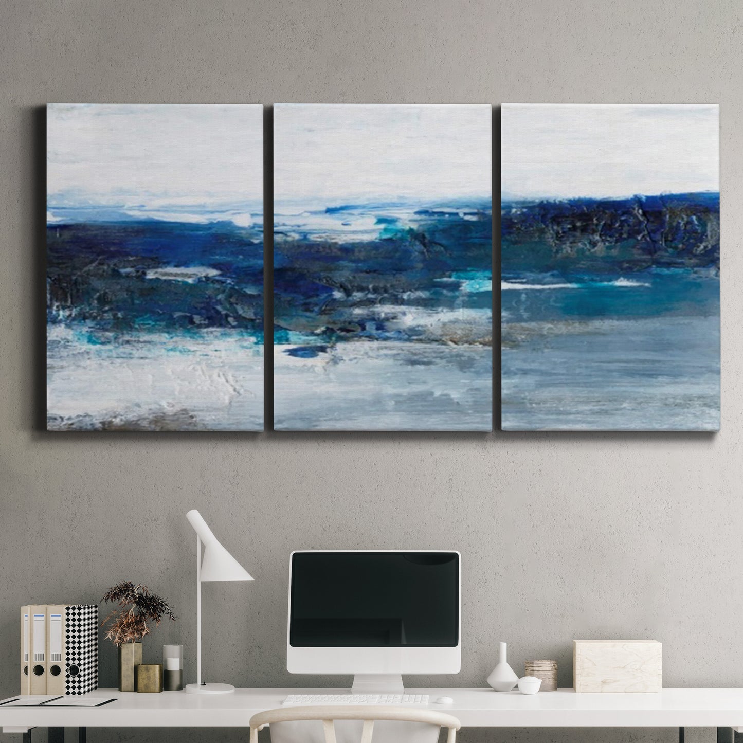 Three-panel canvas wall art featuring moody abstract sea with depth, displayed above a desk in a home office.